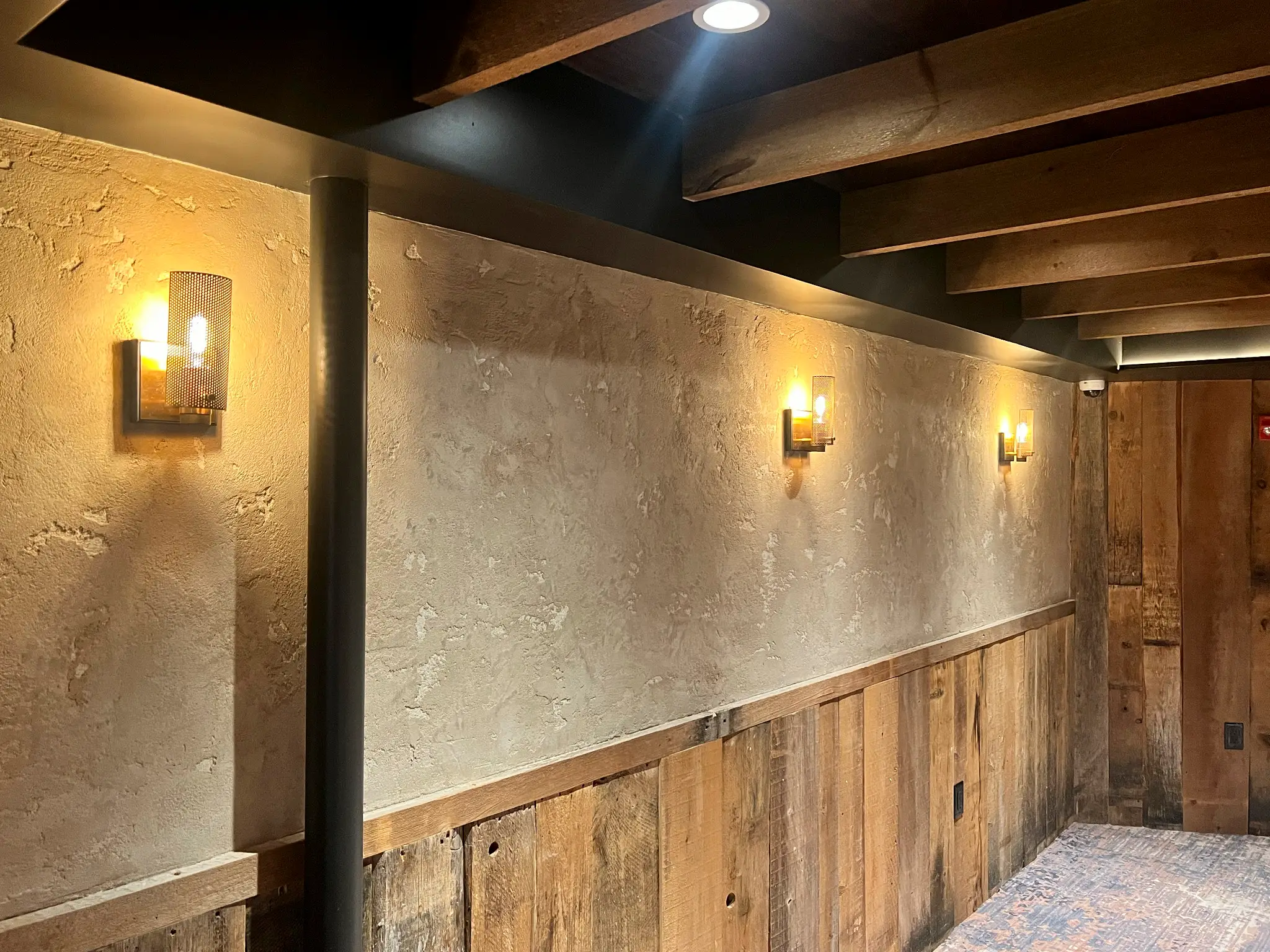 Forge — back dining room lime plaster wall beneath a beamed ceiling