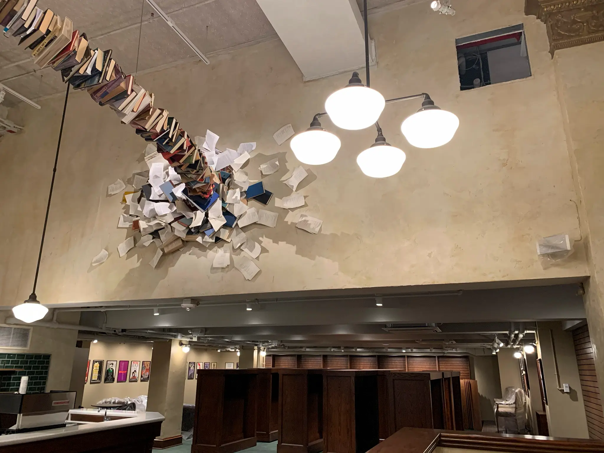 The Drama Book Shop — wide view of the book sculpture spanning the double-height plaster wall