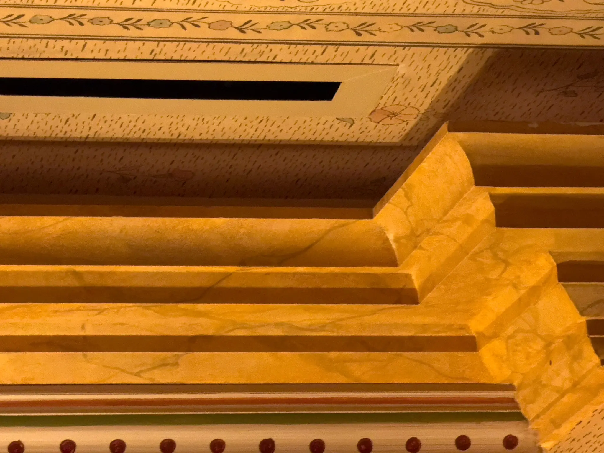 Maxime's — detail of gold leaf crown molding with hand-painted floral border