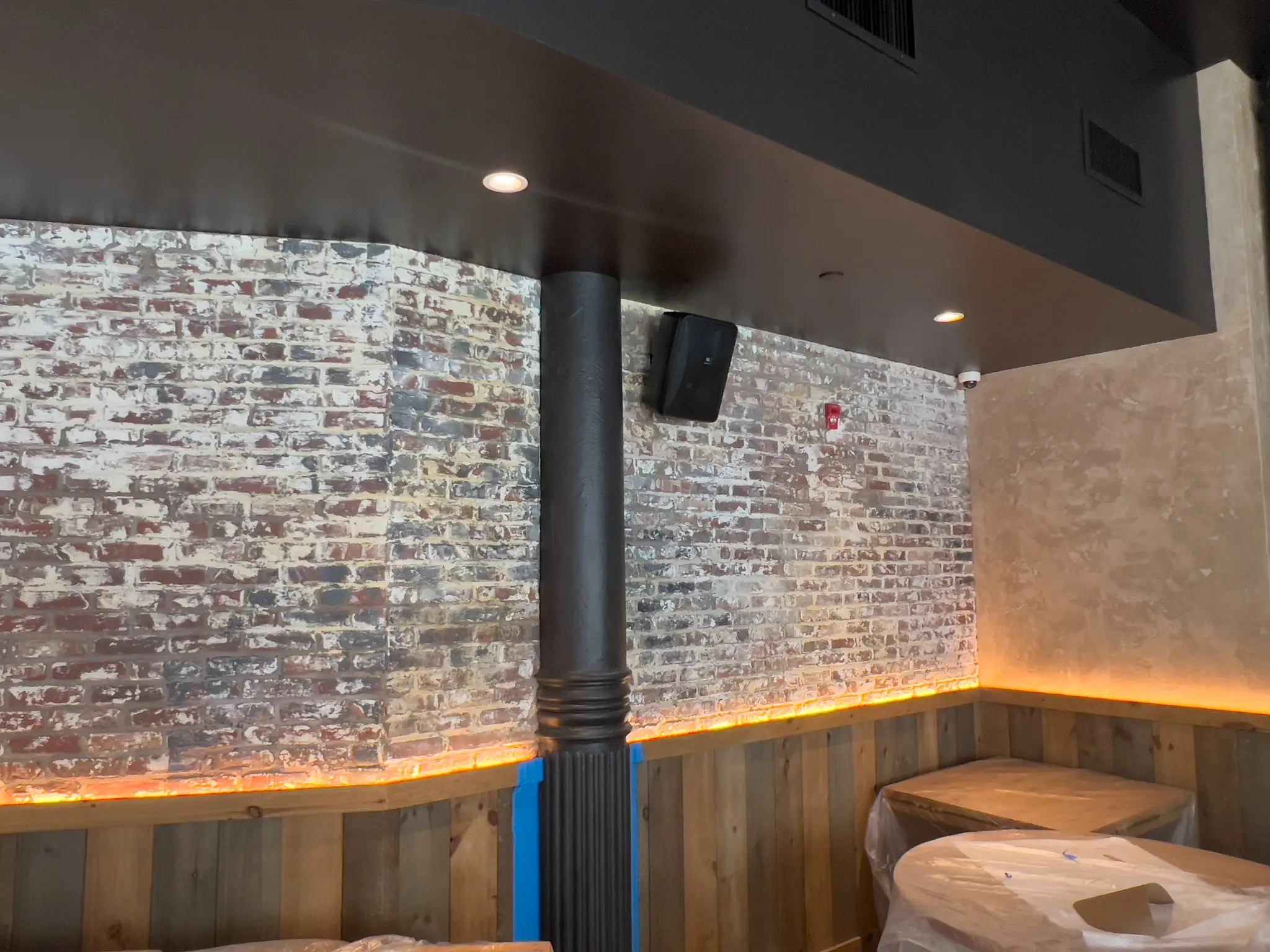 Forge — dining room booth with faux-aged whitewashed brick finish