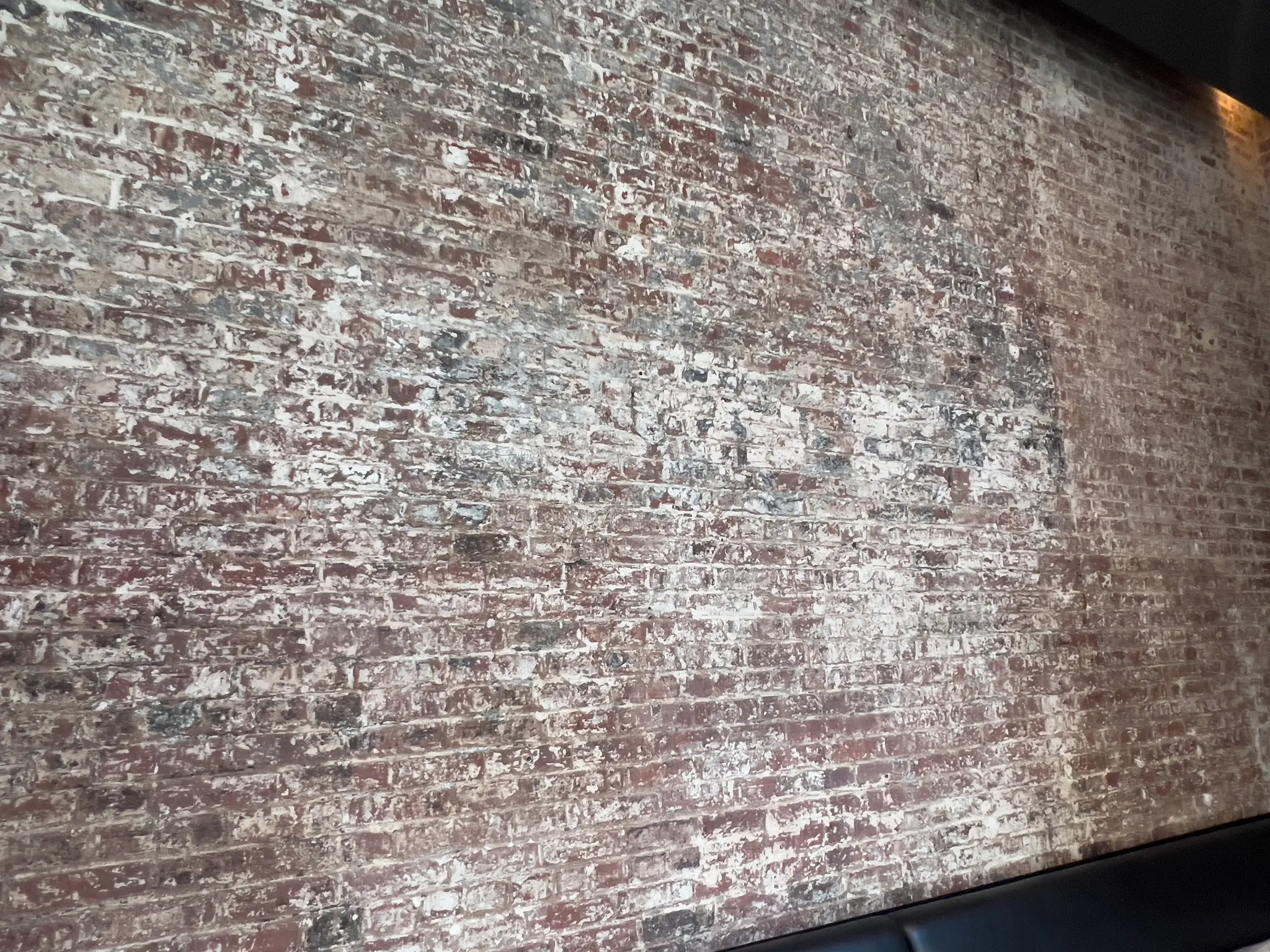 Forge — detail of the faux-aged whitewashed brick finish