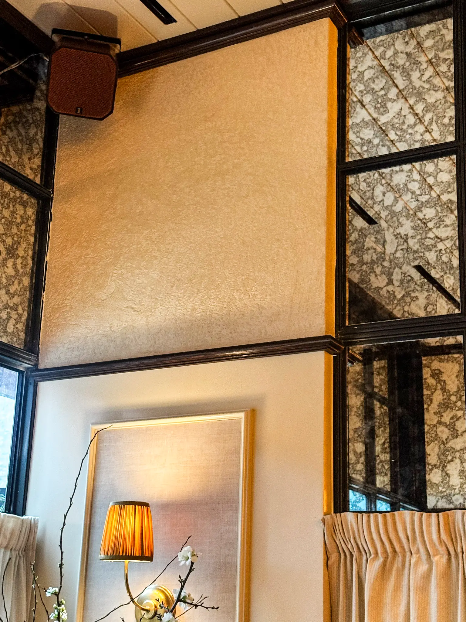 Carversteak NYC — dining room wall in warm gold venetian plaster between antiqued mirror windows