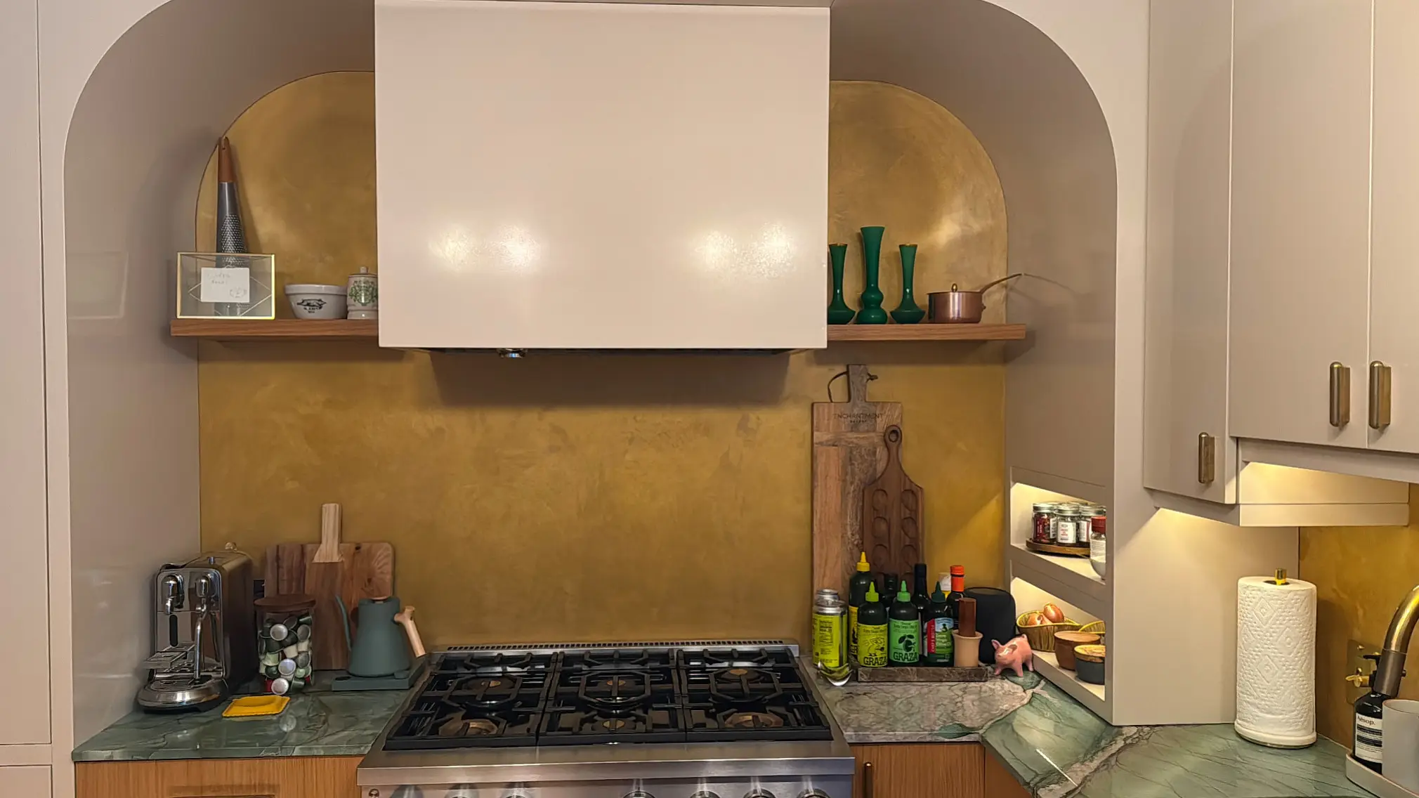 Horatio St. Apartment — kitchen range wall with gold polished-plaster backsplash