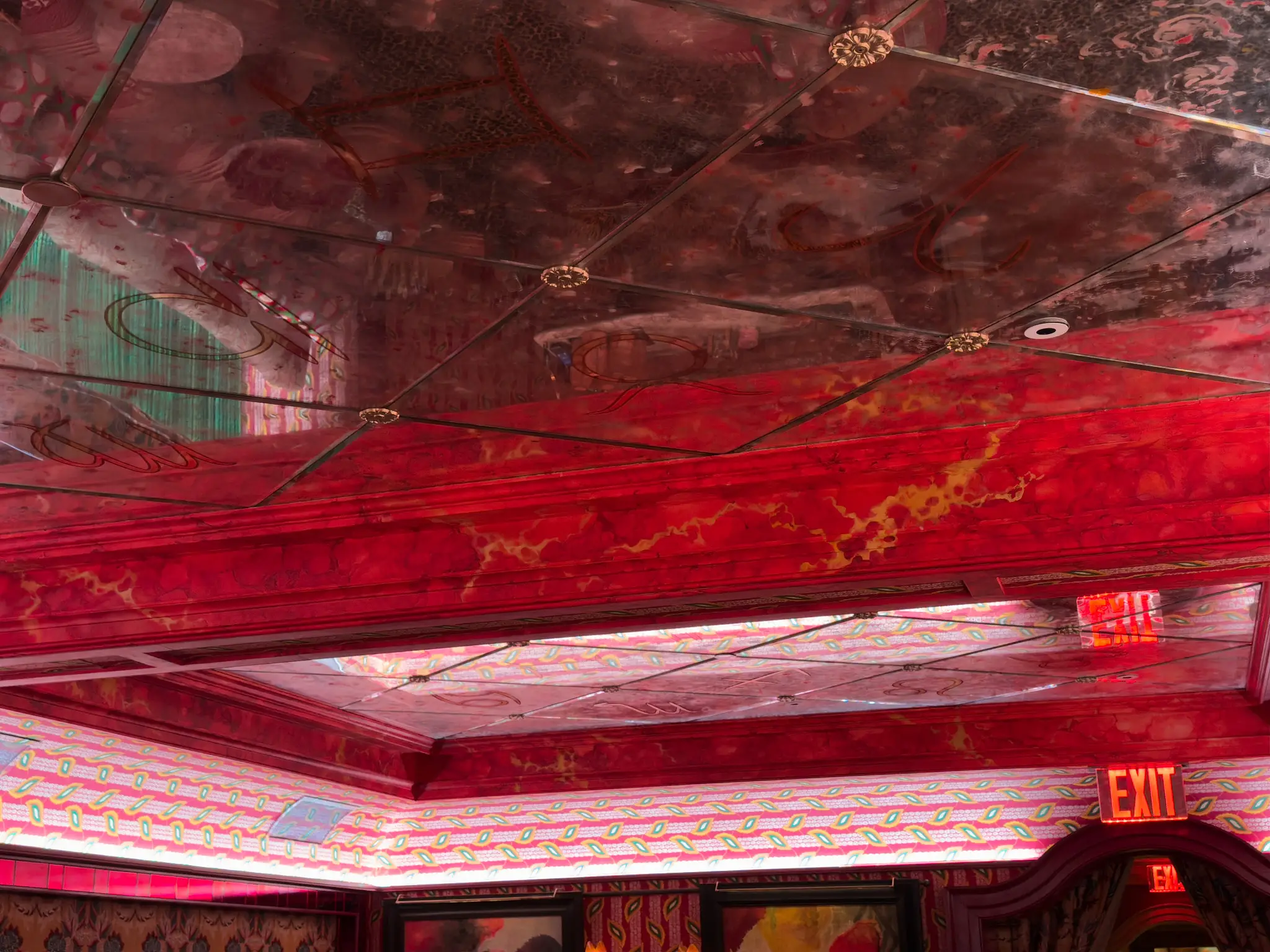 Maxime's — antiqued mirror ceiling panels with gilded rosettes