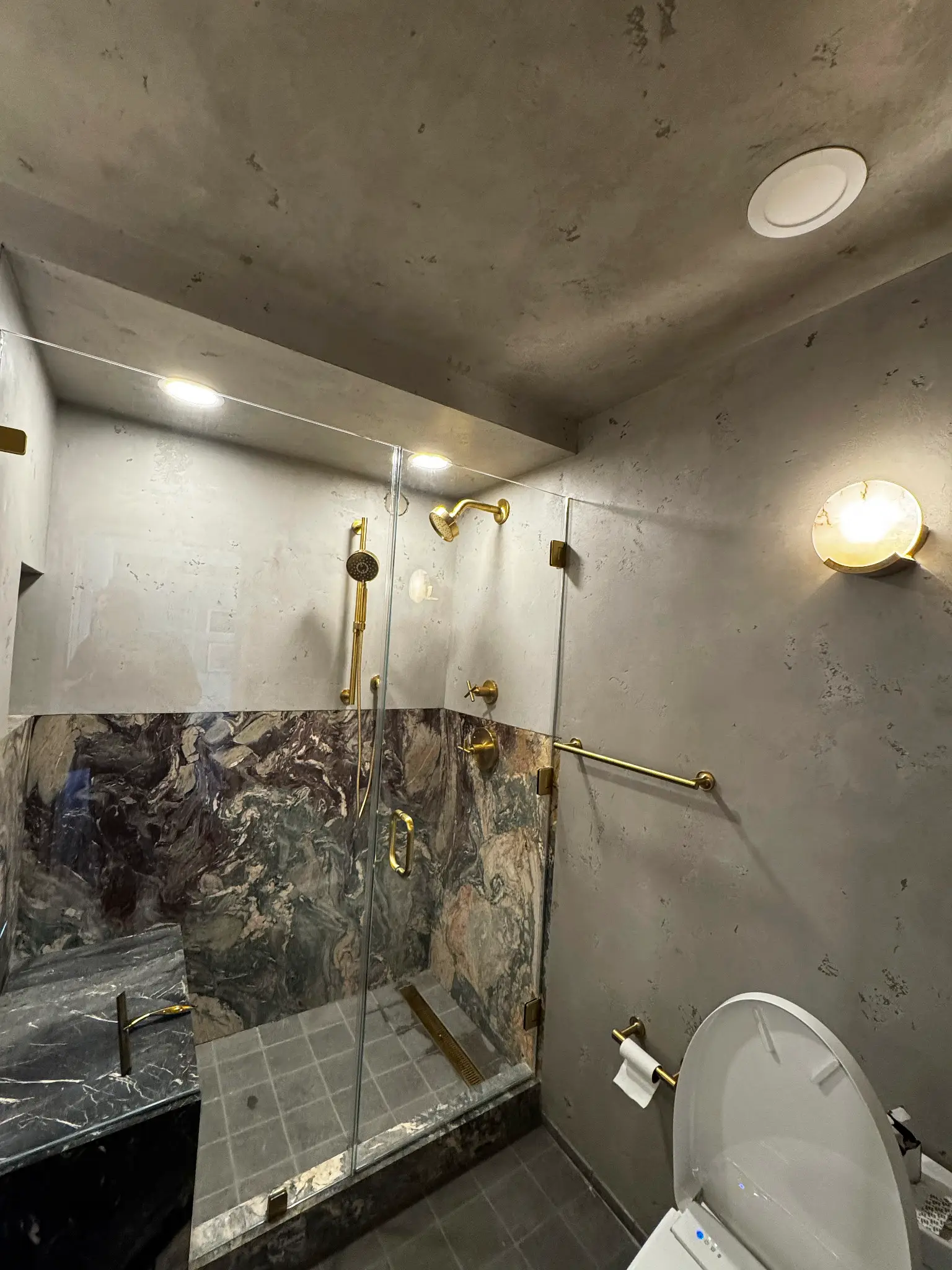 Horatio St. Apartment — primary bathroom shower with grey venetian plaster and marble